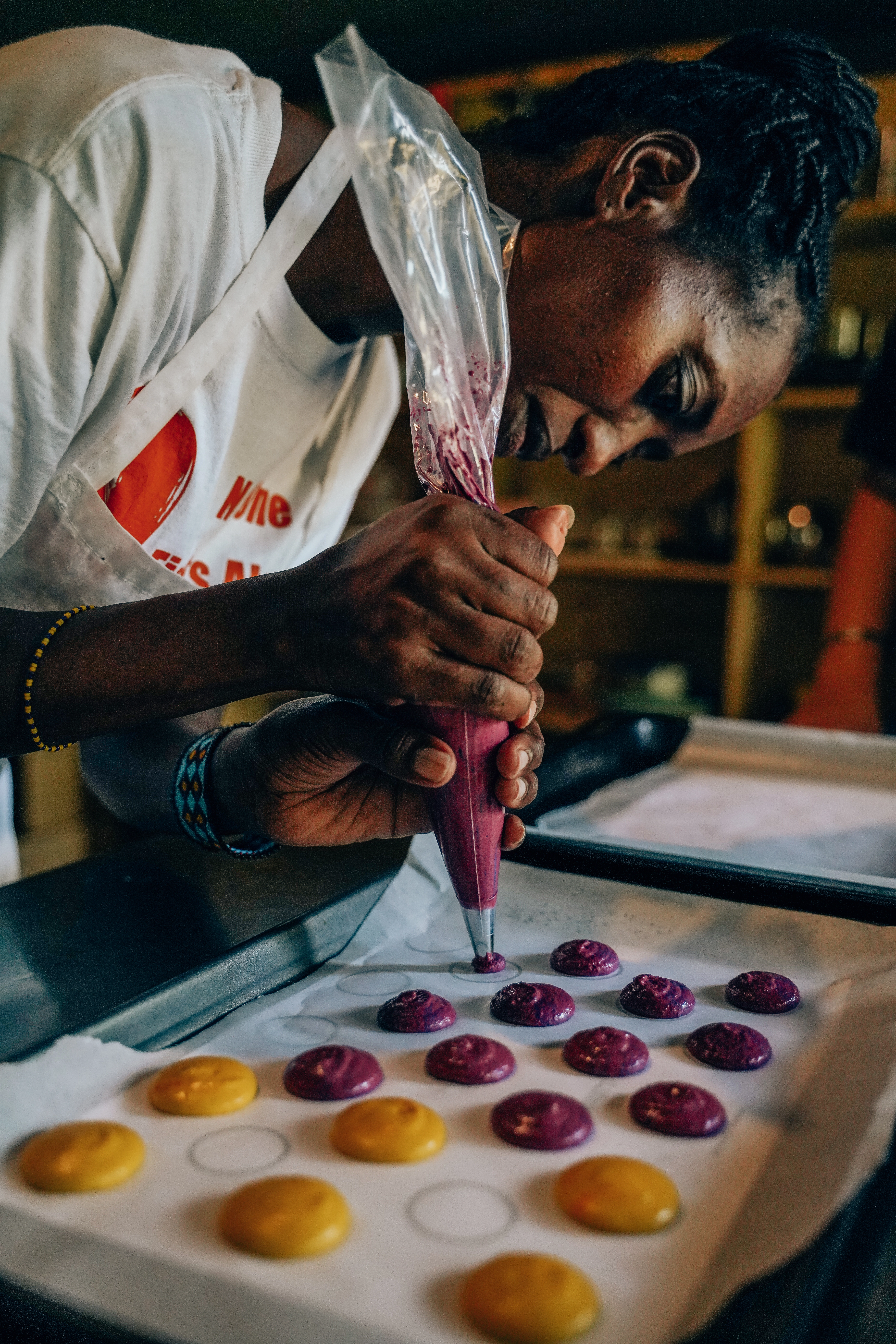 enkusero-kenya-training-macarons-piping On-site pastry training in Kenya — piping macaron shells (purple & mango)