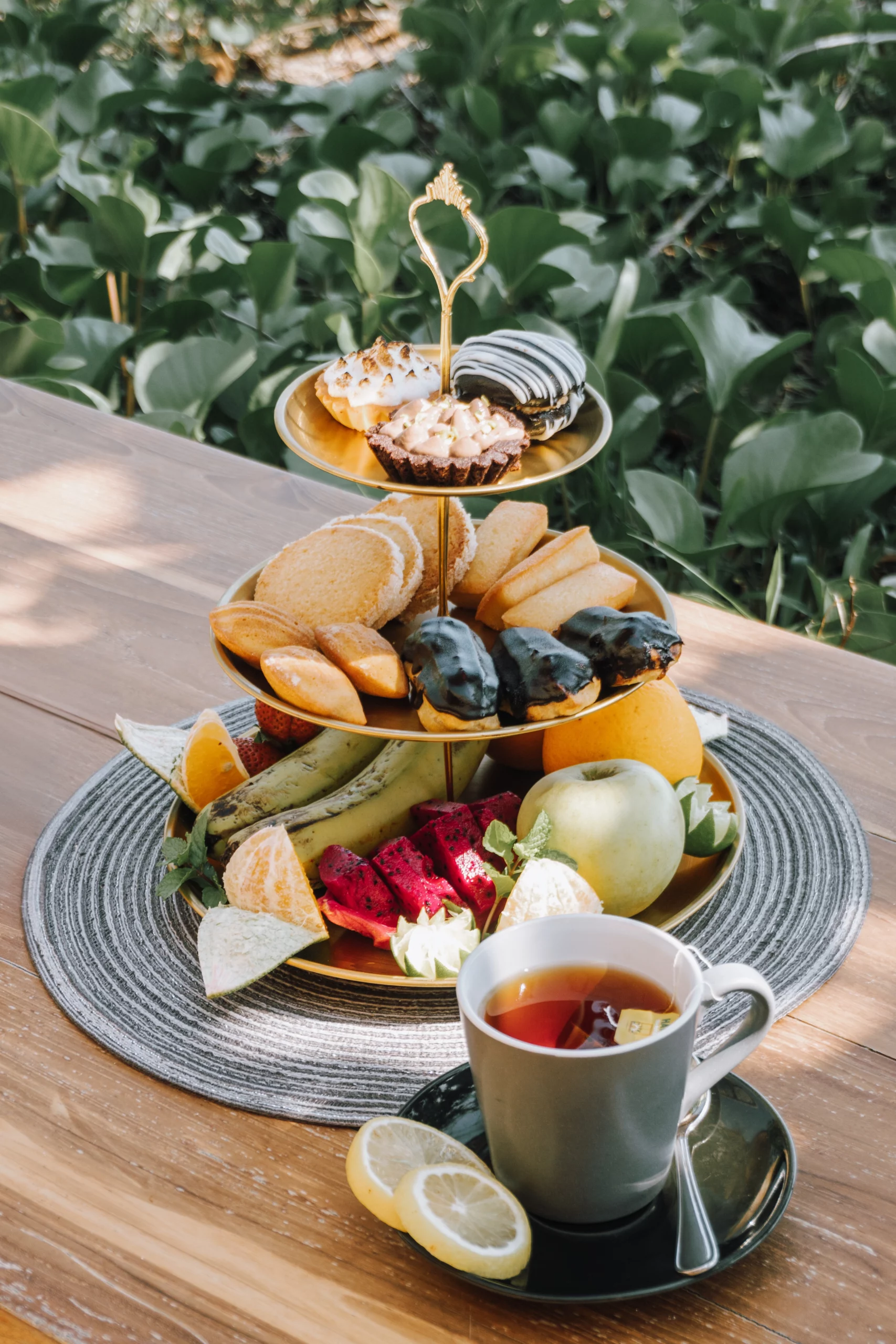 lombok-tea-time-three-tier Three-tier tea-time stand with éclairs, tartlets, madeleines and fruit — island resort in Lombok