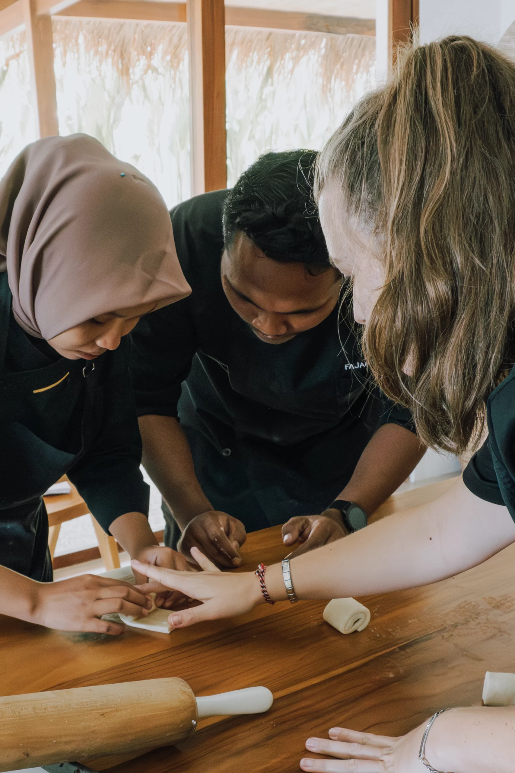 lombok-training-hands-on-dough On-site pastry training in Lombok — hands-on dough shaping with the kitchen team